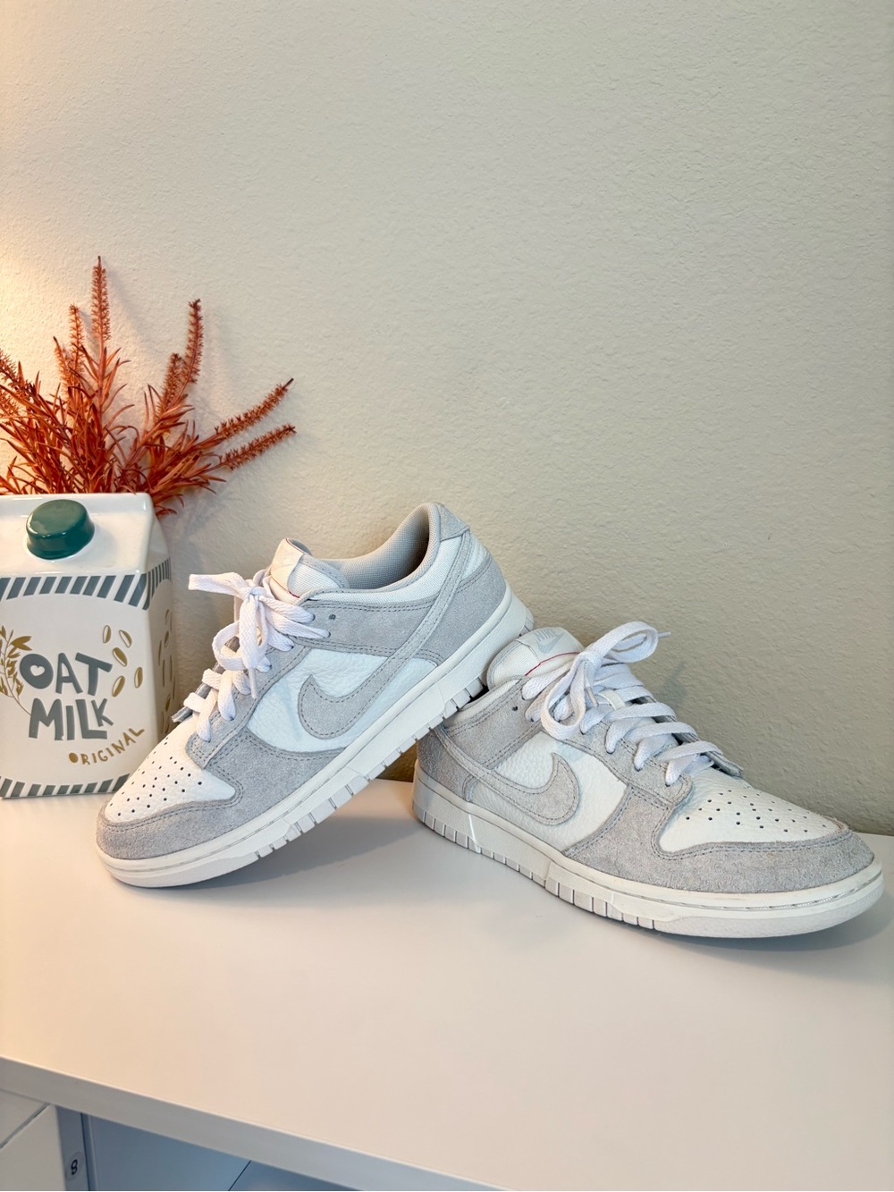 Nike Dunk Low in “Summit White Photon Dust” women’s sneakers.